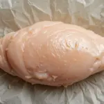 Raw Chicken Breast On Parchment Paper