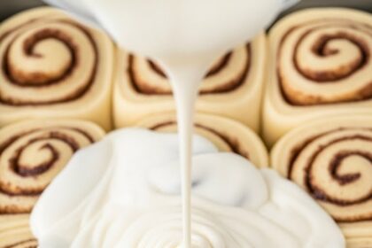 Adding Cream To Cinnamon Rolls